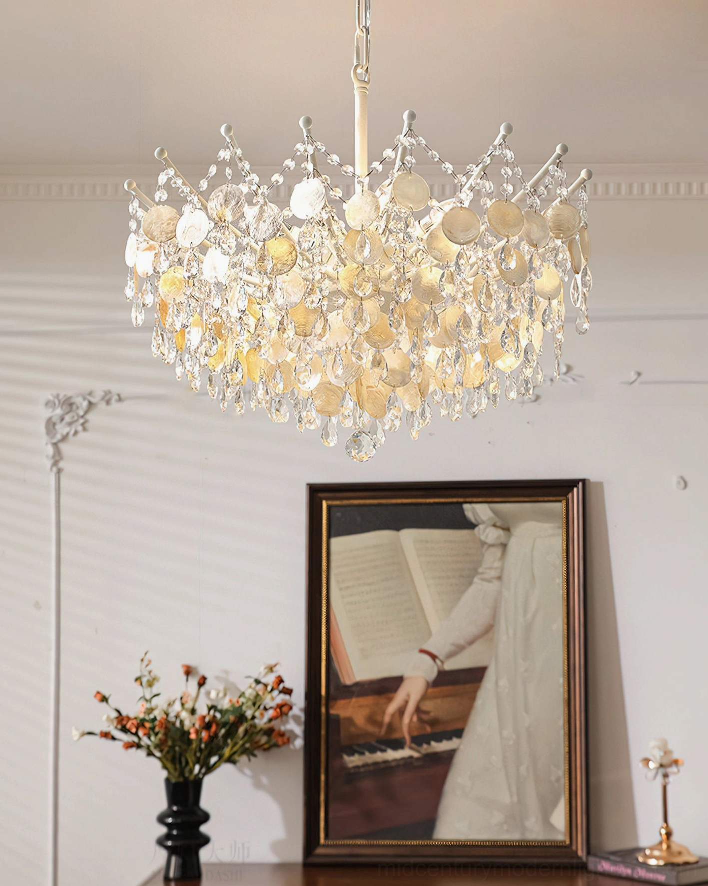 Champagne gold capiz shell chandelier close-up with clear crystal accents and warm-toned beads, white metal frame visible