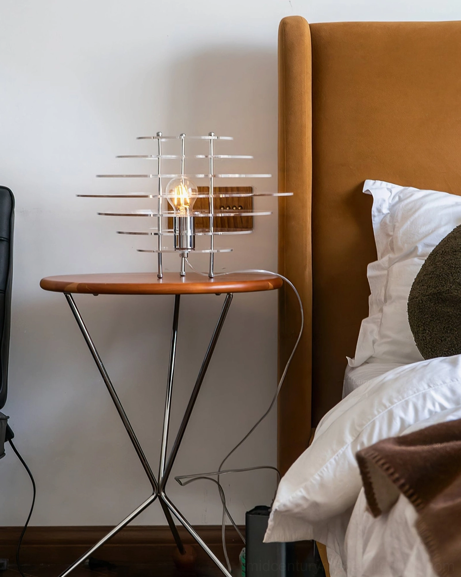 Saturn chrome lamp wide side angle on cozy bedroom with brown fabric headboard - minimalist modern lighting