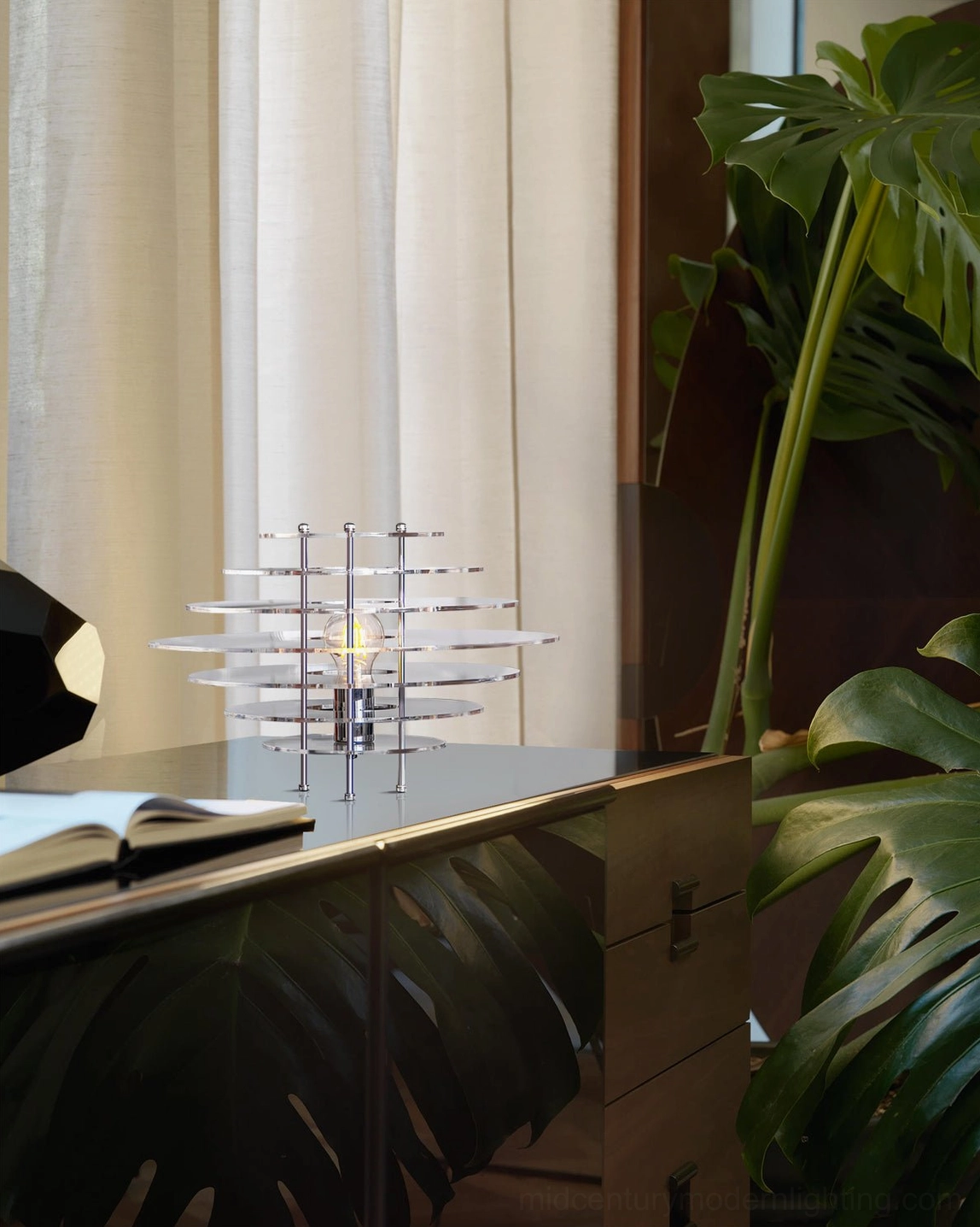 Saturn table lamp eye-level side view on console table with tropical plant - tropical modern minimalist decor