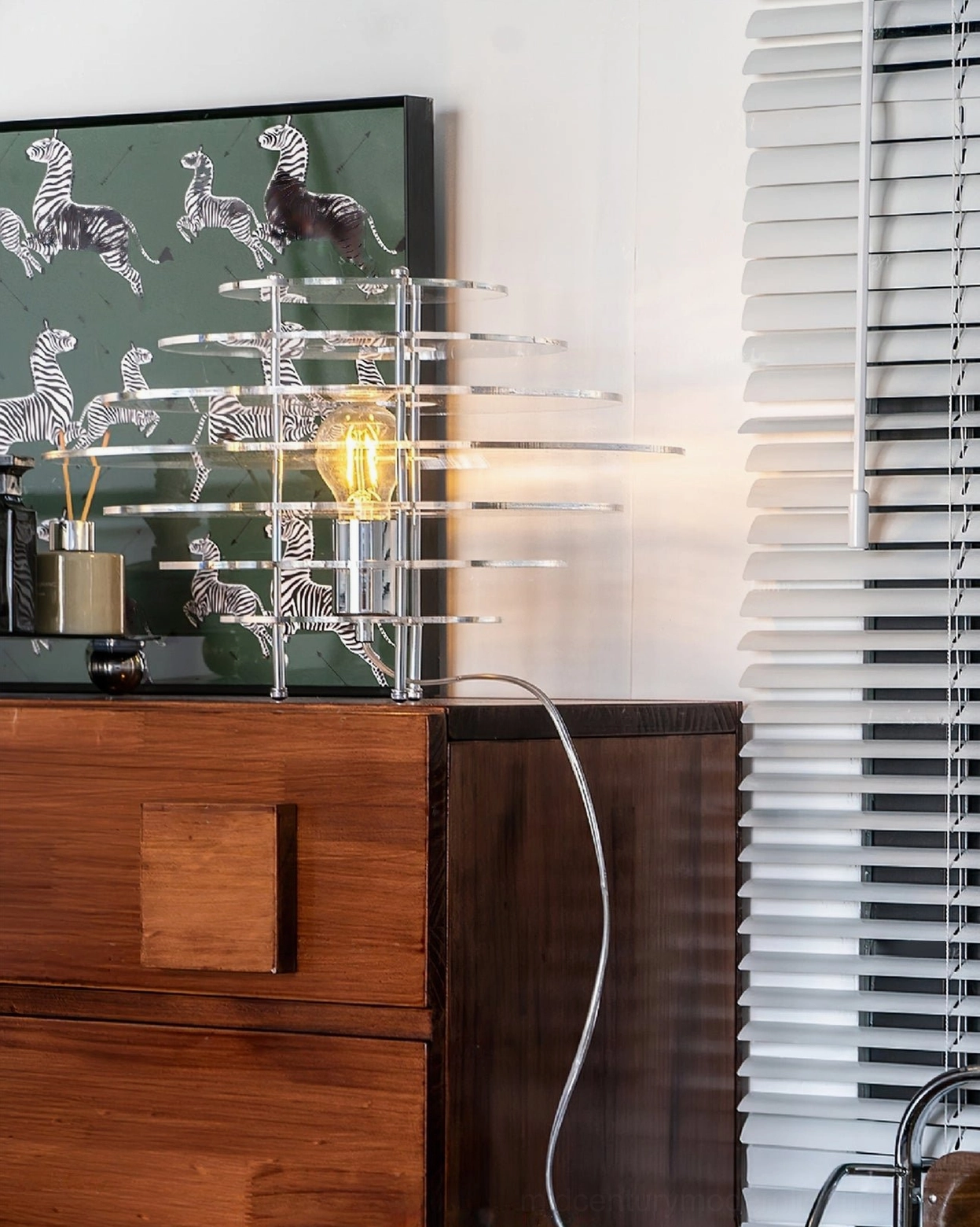 Saturn lamp frontal three-quarter view on wooden dresser with zebra wall art - mid-century modern aesthetic