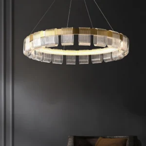 Saturno contemporary pendant light with ribbed clear glass accents and brass metal frame, eye-level perspective