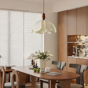 Savoy fabric pendant light suspended above mid-century modern wooden dining table in warm vintage interior