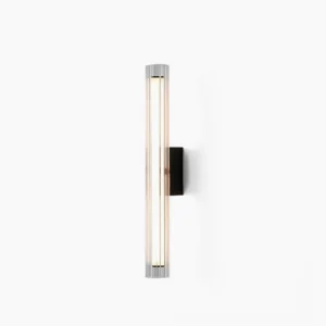 Saxon modern wall lamp with ribbed glass shade in front studio view