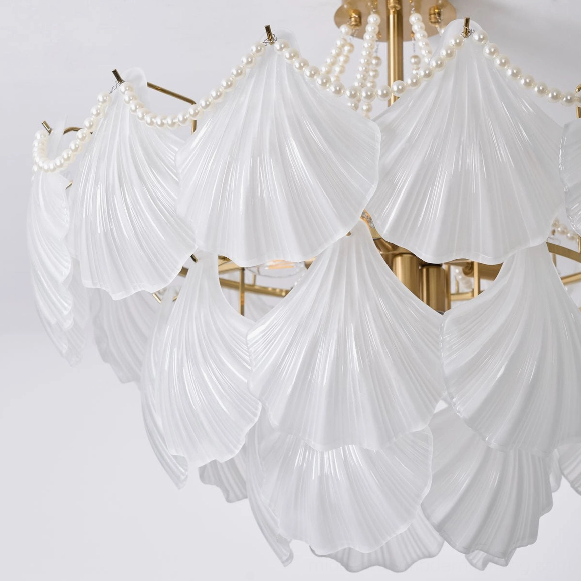 Scallop shell chandelier in elegant entryway creating dramatic focal point with warm ambient glow