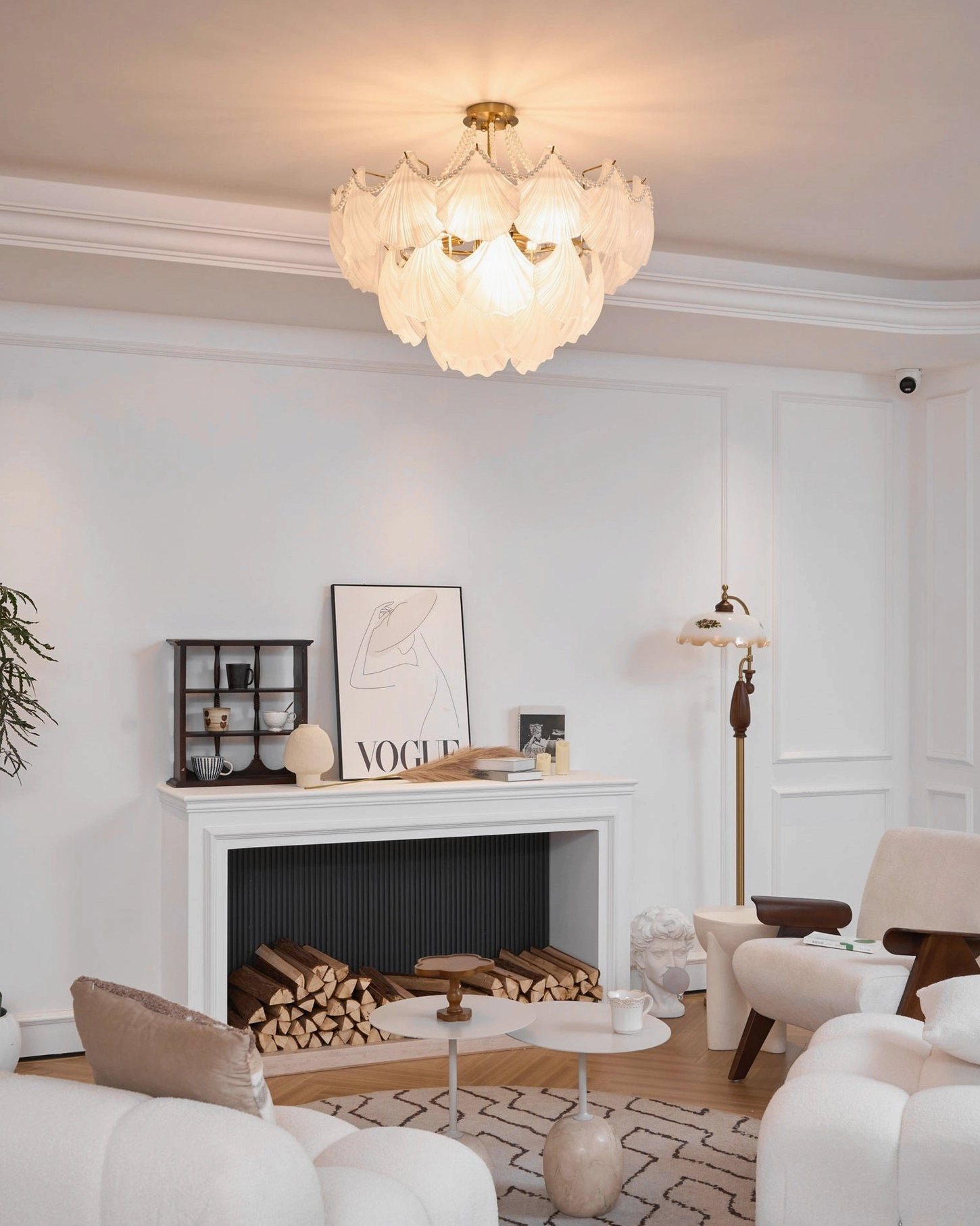 Scallop shell chandelier in neoclassical interior with ornate molding and sophisticated brass framework