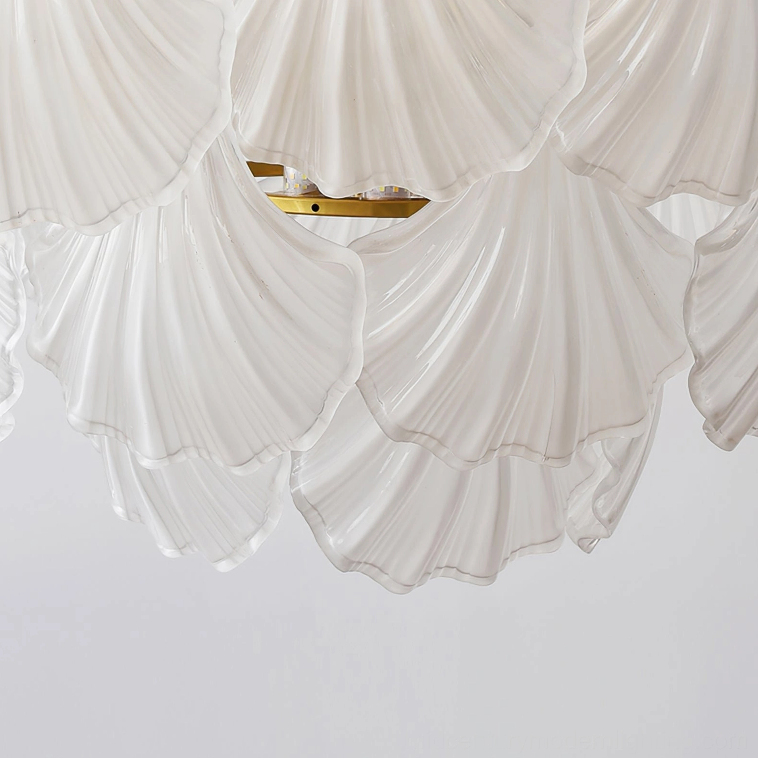 Overhead flat lay view of scallop shell chandelier shades showing layered frosted milky white glass design
