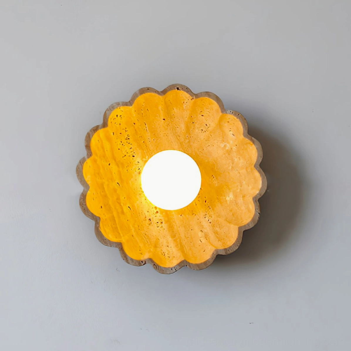 Fully lit scallop wall lamp with continuous warm yellow lighting on light gray background