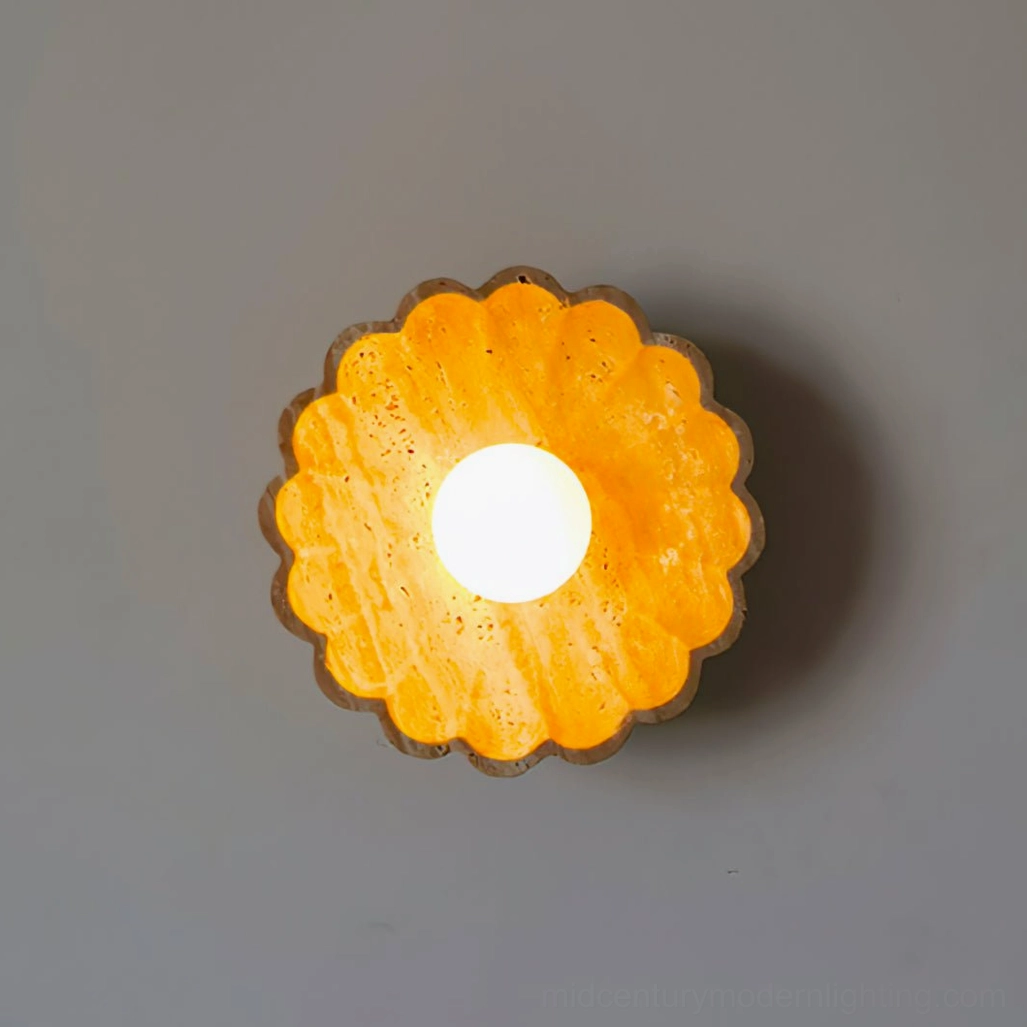 Illuminated scallop wall lamp emitting warm ambient glow on dark gray wall
