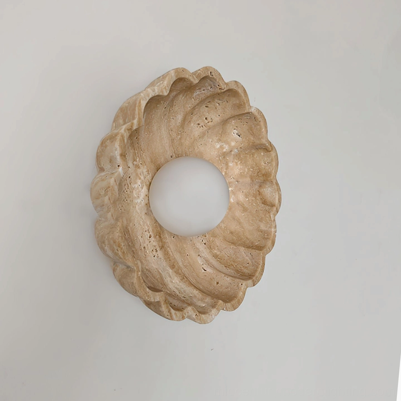 Scallop wall lamp base without bulb showing travertine scalloped frame on white background