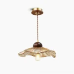 Scalloped floral pendant lamp with amber glass shade overhead studio view mid-century modern