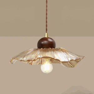 Close-up side view of scalloped amber glass pendant showing ruffled edges and twisted brown cord
