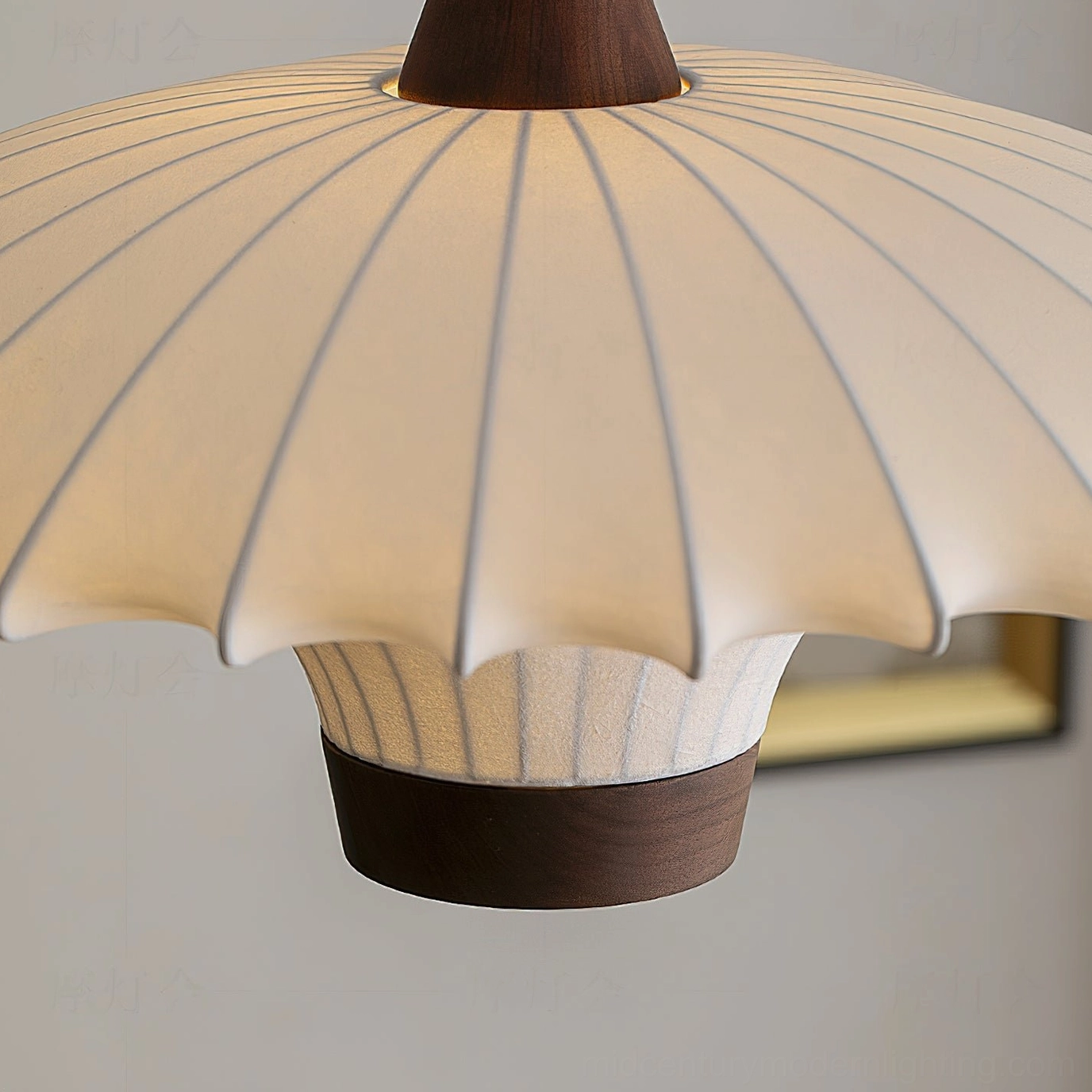 Scalloped pleated fabric pendant light bottom view with dark wood base ring against white background