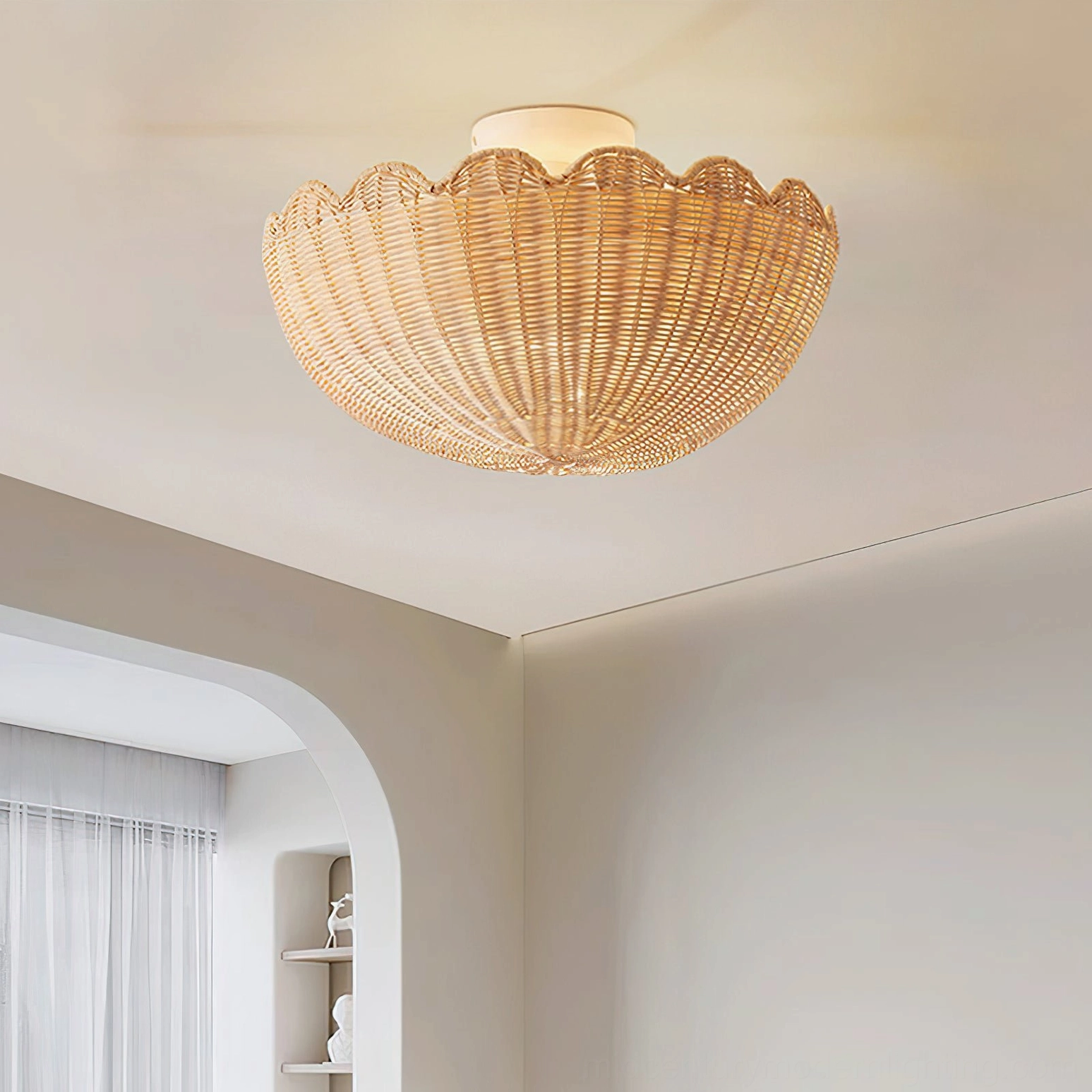 Flush mount rattan ceiling light in minimalist living room with arched doorway showing radial woven pattern and scalloped edge
