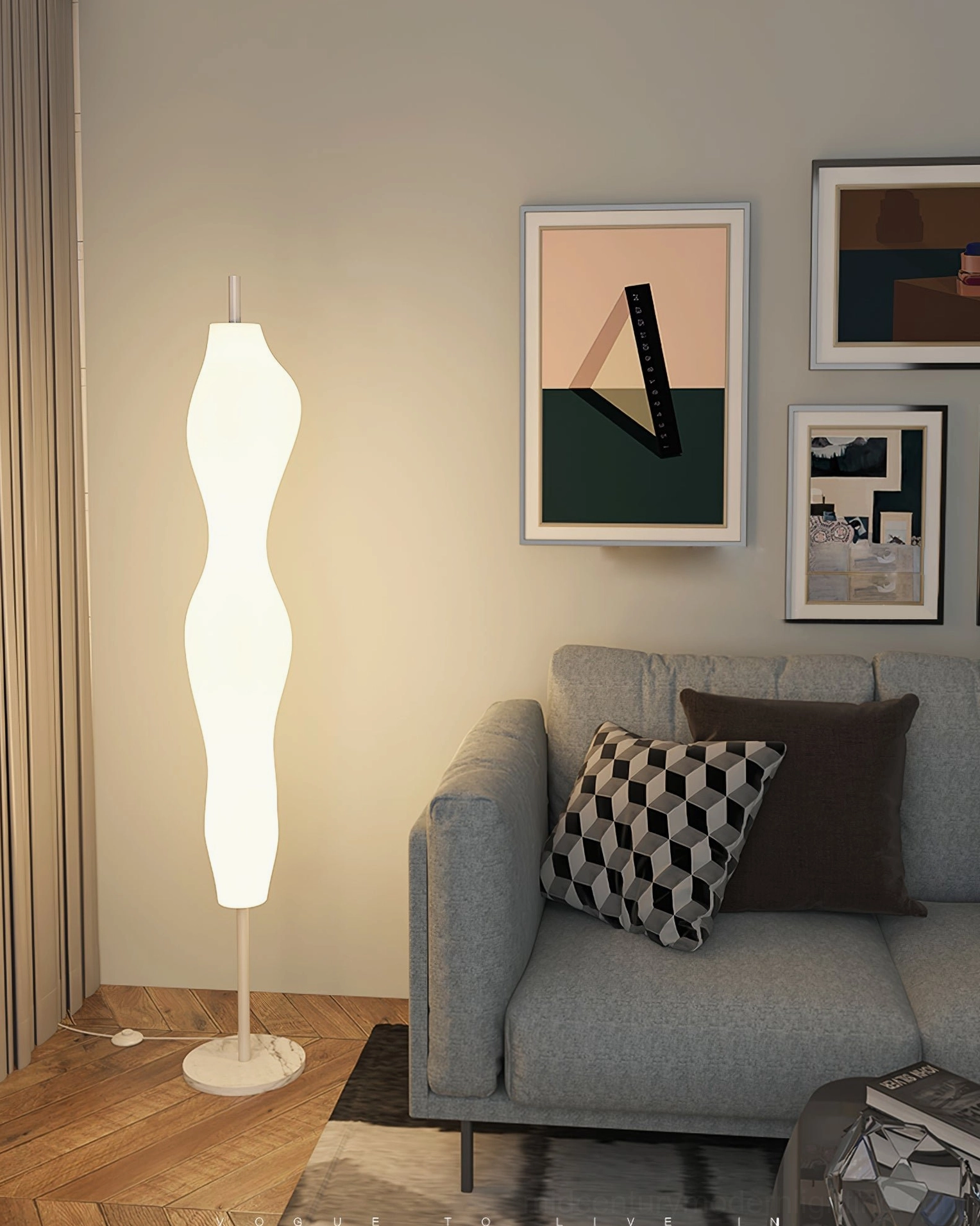 Biomorphic curved lamp beside contemporary gray sofa with gallery wall
