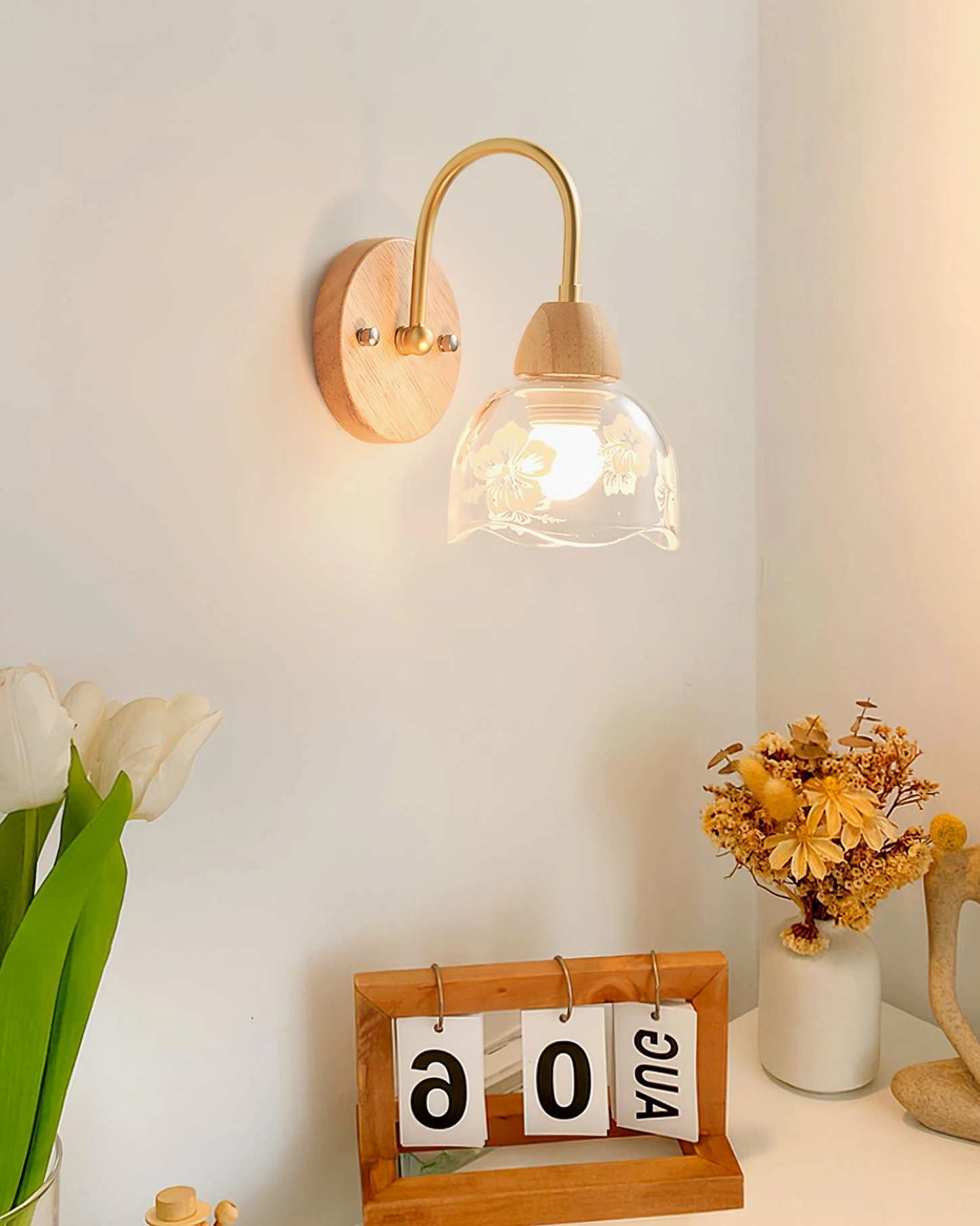 Minimalist floral wall sconce displayed on home office desk with botanical accessories