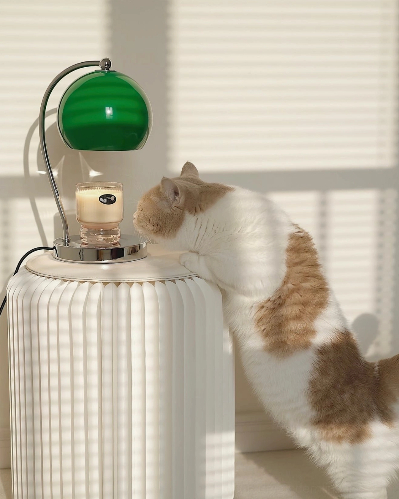 Mid-century sphere table lamp on ribbed cylindrical stand with cat in cozy home setting