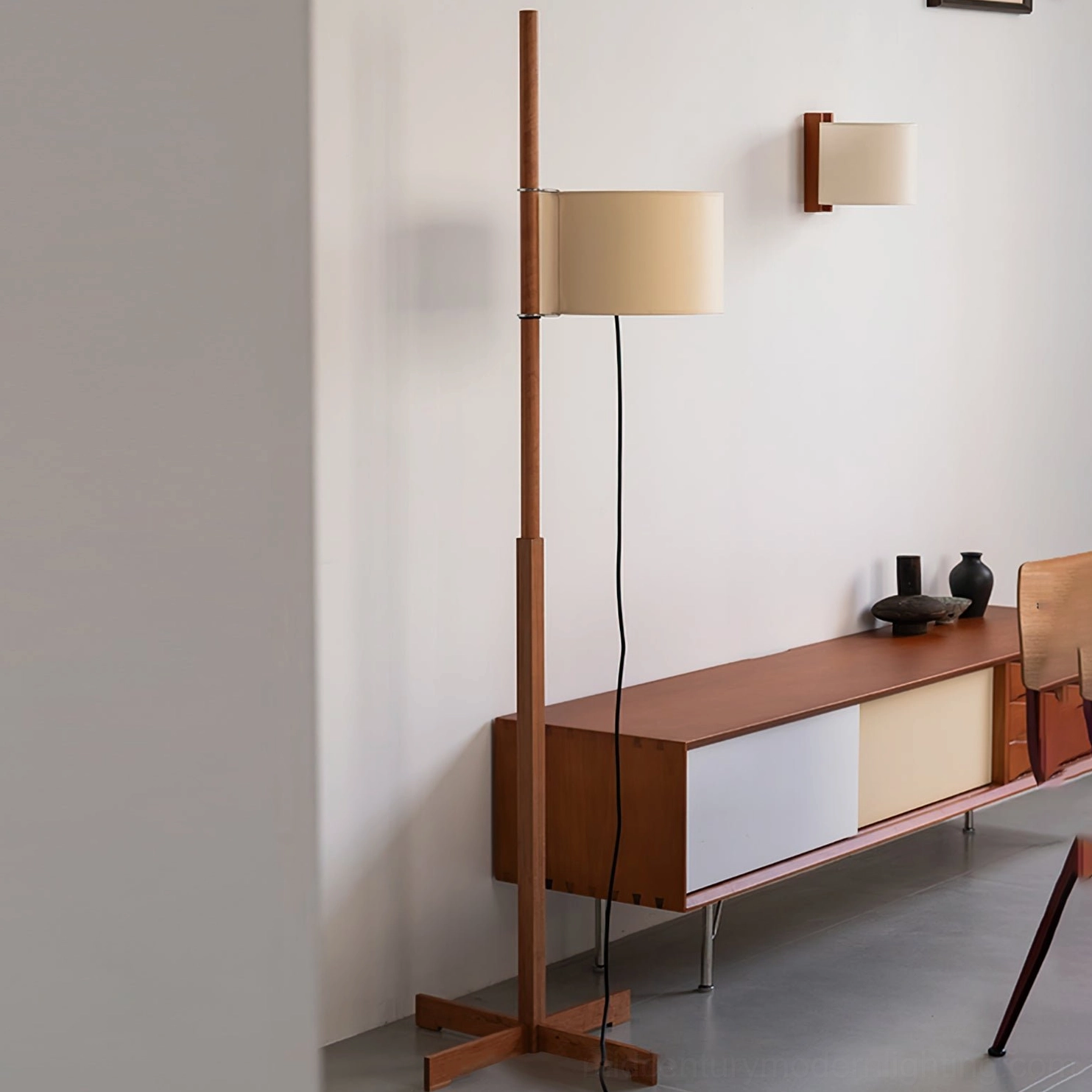 Wooden floor lamp positioned in modern living room interior with side cabinet styling