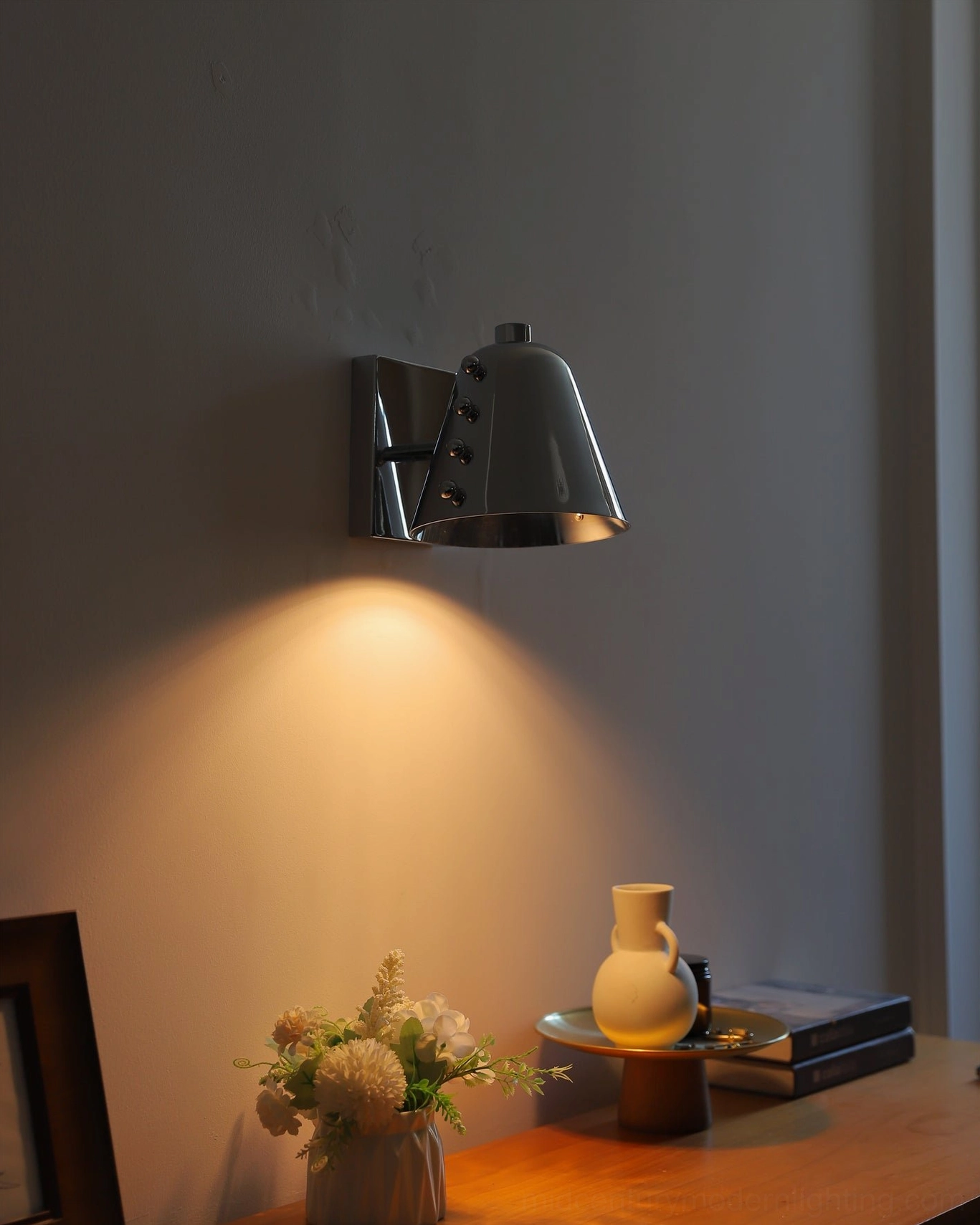 Wall sconce providing soft task lighting in contemporary bedroom ambient lighting design