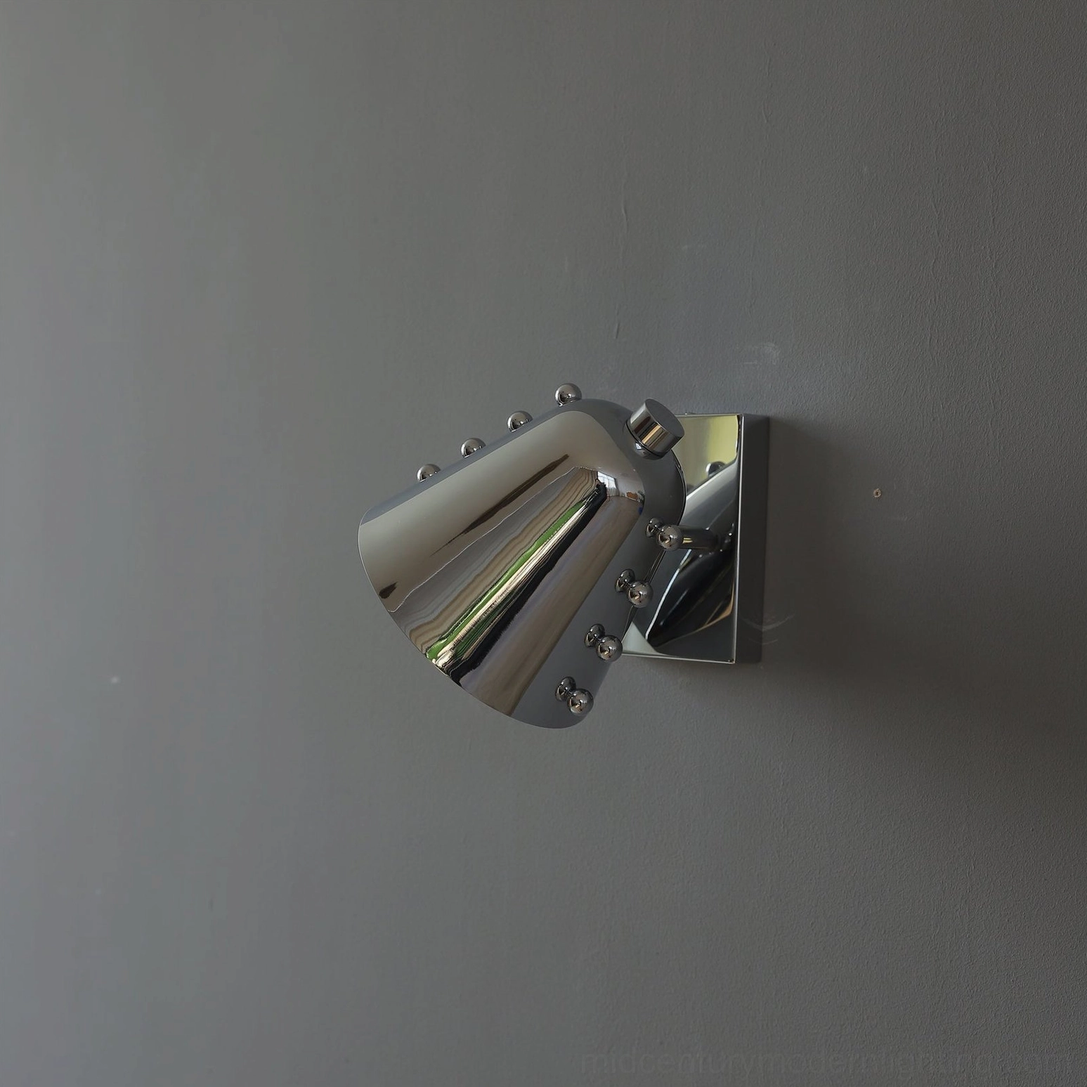 Geometric wall sconce with Edison bulb creating vintage-modern aesthetic and warm ambiance