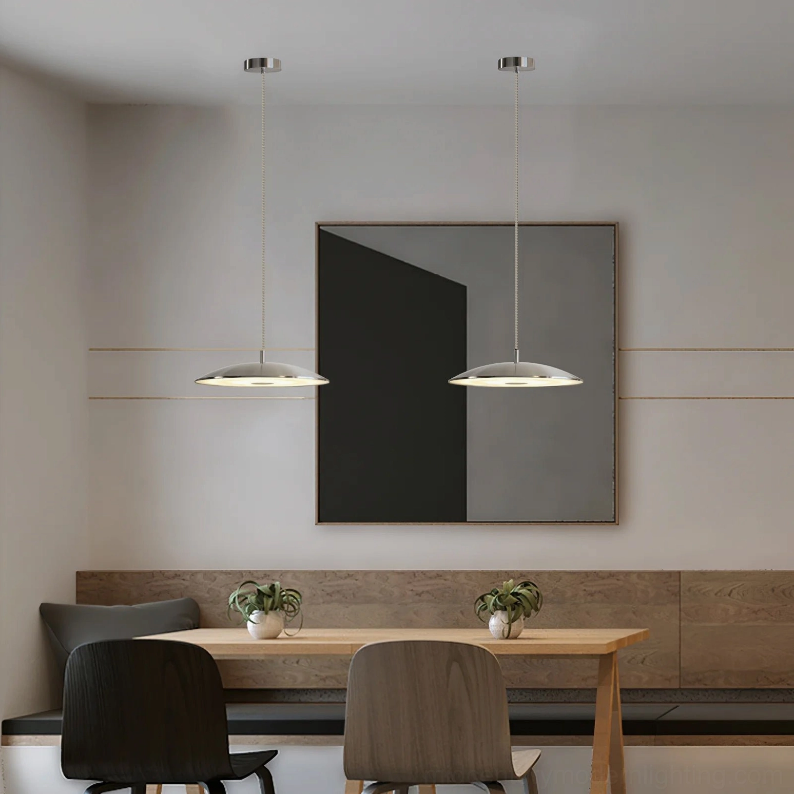 Two silver scope LED pendants in dining lounge with wall artwork and warm neutral decor