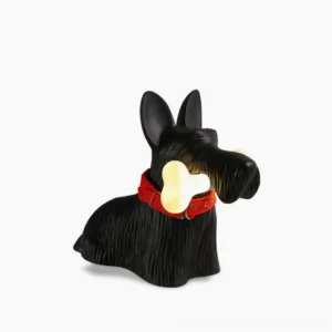 Scottie terrier table lamp with black matte finish and glowing bone light, studio front-side profile view