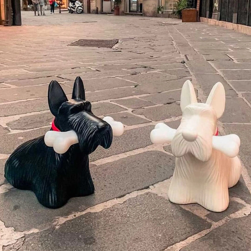 Black and white Scottie terrier lamps side by side, contemporary lighting sculpture pair outdoors on stone plaza