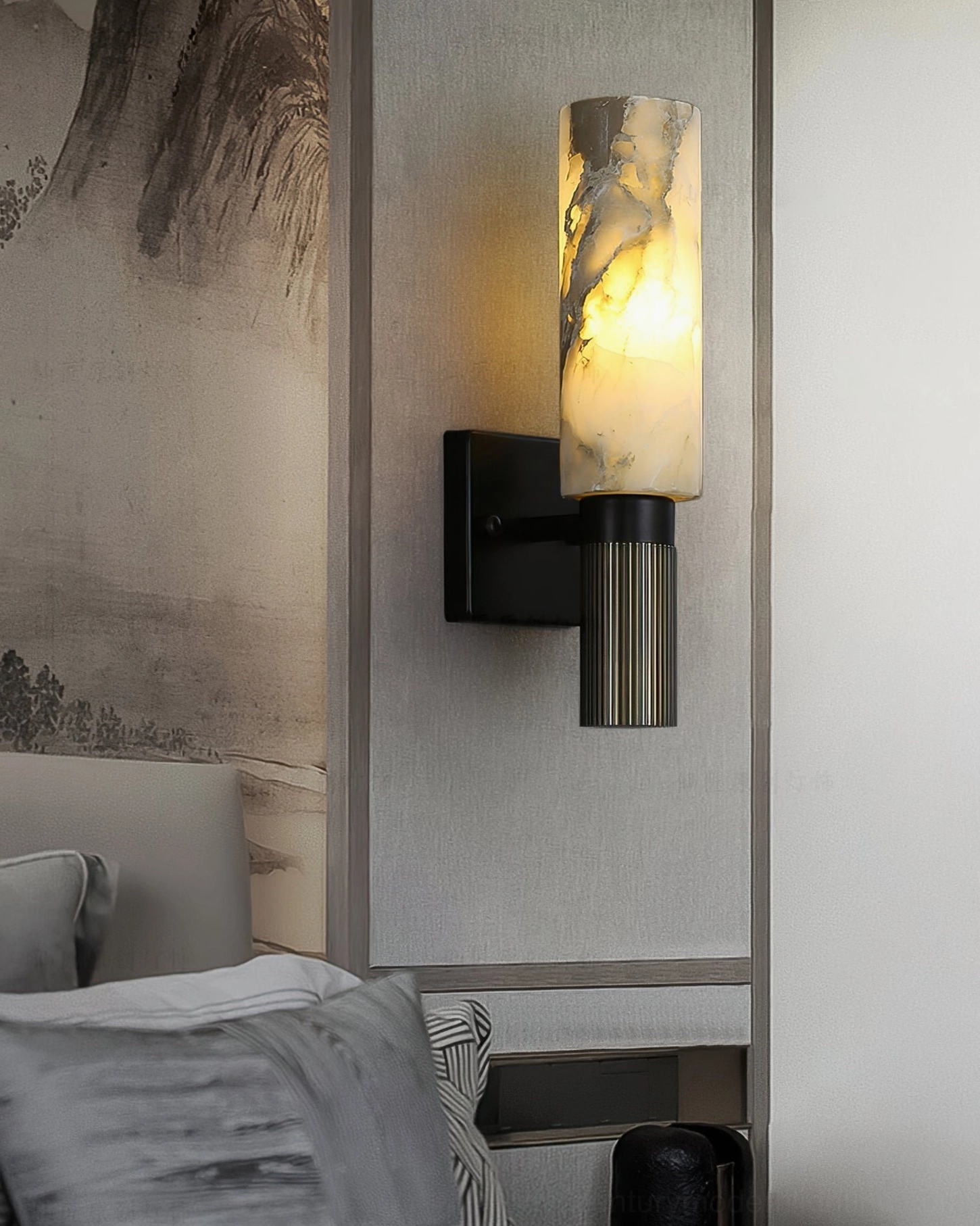 Sculptural alabaster cylinder wall lamp mounted at eye level, showcasing minimalist mid-century design aesthetic