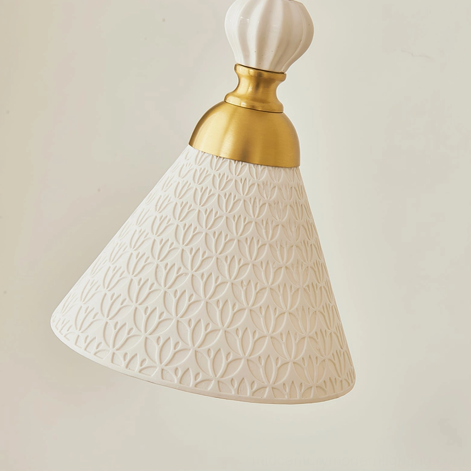 Handcrafted ceramic pendant lamp showing sculptural silhouette and twisted fabric cord suspension