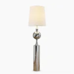 Sculptural chrome floor lamp with articulated arm and off-white fabric shade on pure white background - front view showing modern minimalist design