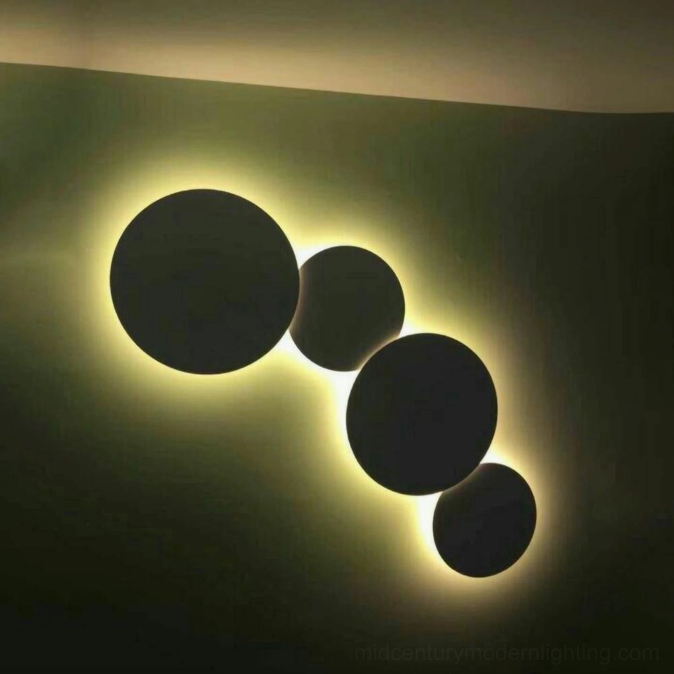 Sculptural disc wall lamp demonstrating energy-efficient LED technology integrated with geometric mid-century design