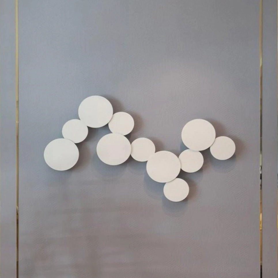 Sculptural disc wall sconce mounted in modern interior highlighting warm color temperature and diffused light quality