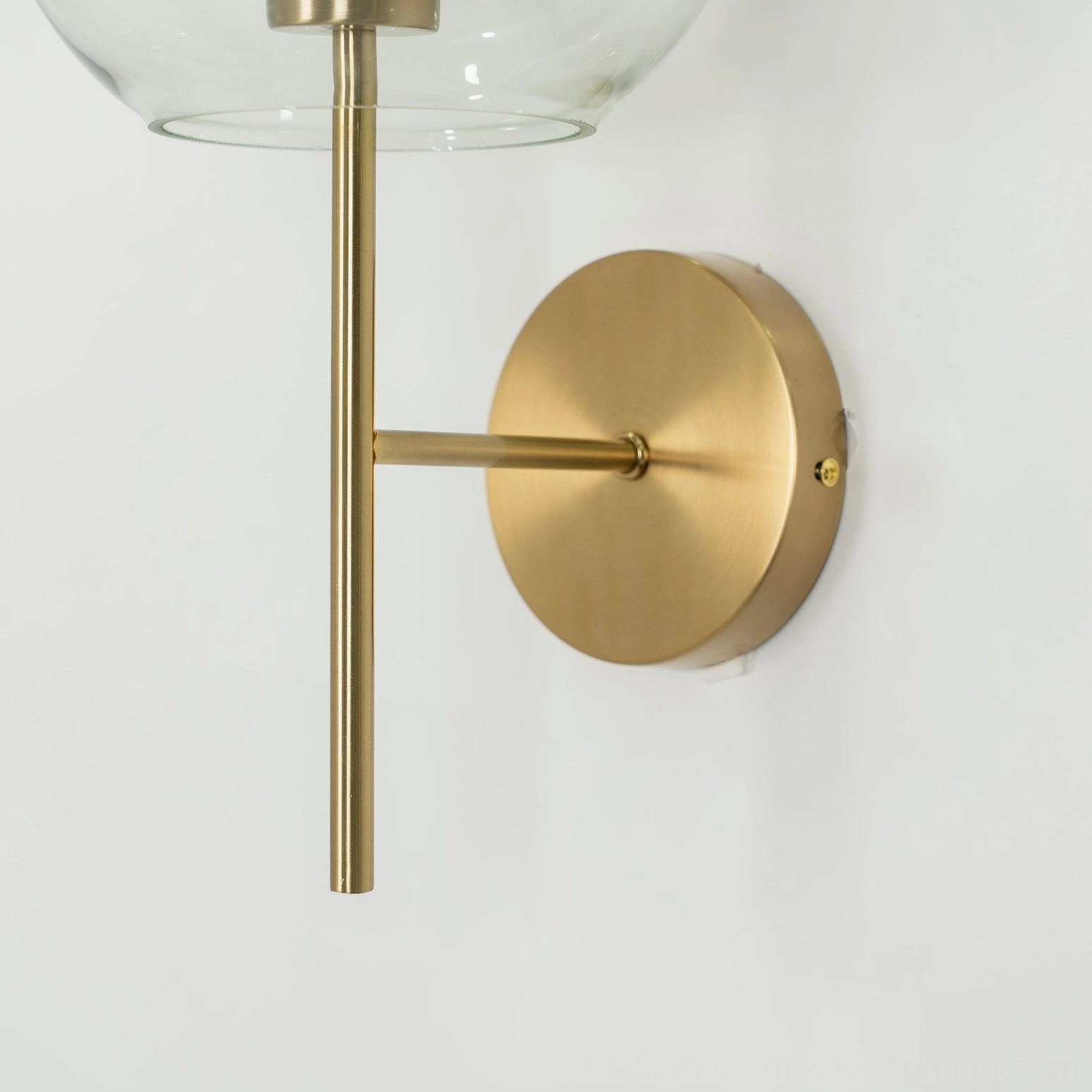 Modern glass wall sconce with sculptural glass orb and minimalist mounting