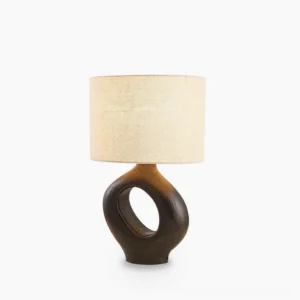 Sauce sculptural resin table lamp with hollow ceramic base, front view on white background, minimalist modern design