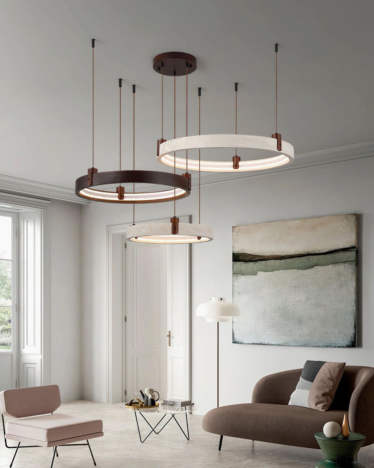 Three-tier sculptural travertine ring chandelier in living room with wall artwork, showcasing textured dual-tone finish design