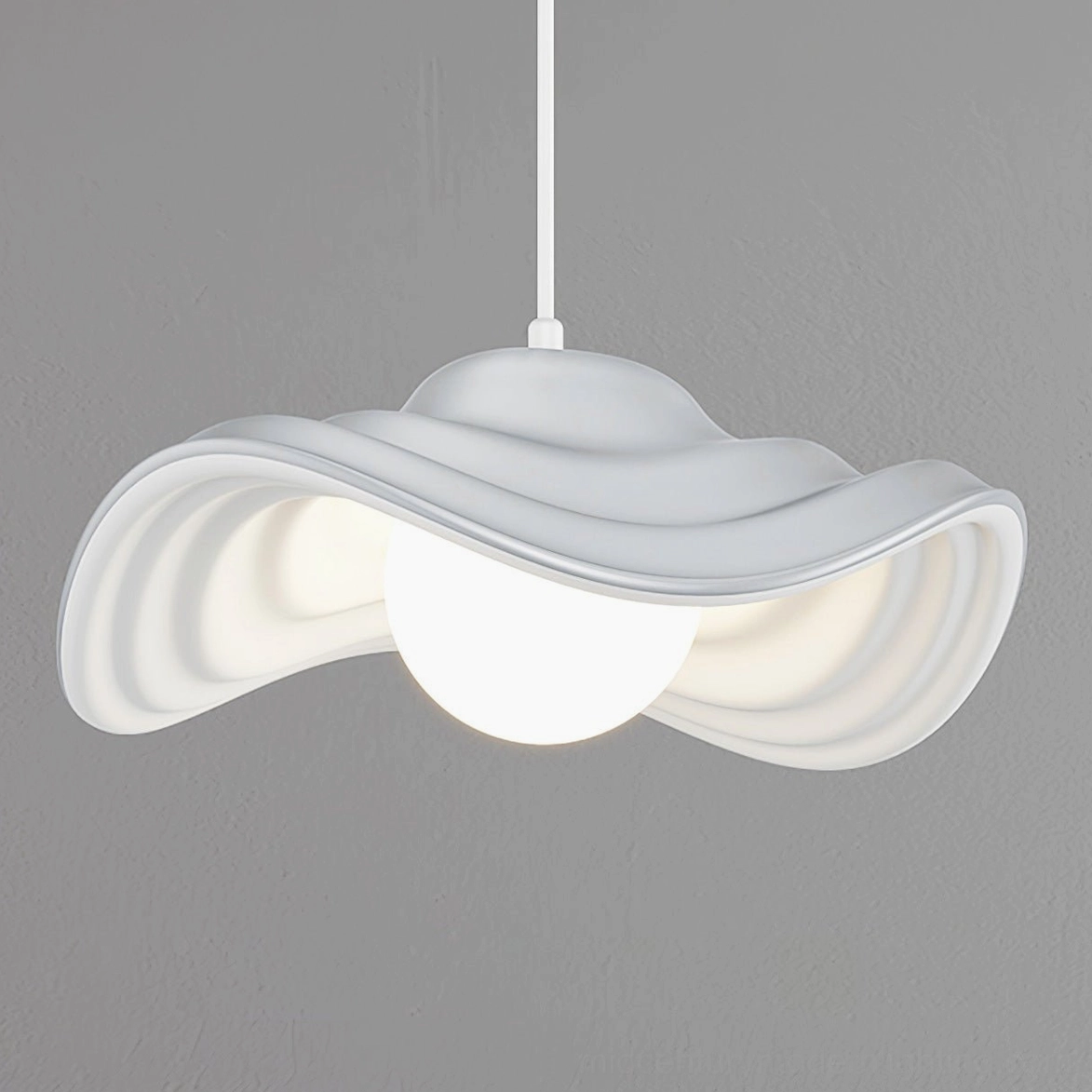 Sculptural wavy pendant lamp demonstrating biophilic design philosophy with organic flowing form in contemporary interior space