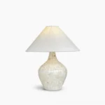 Seashell mosaic table lamp with creamy white fabric shade and handcrafted shell inlay base, studio lighting on white background