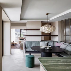 Seashell pendant light installed in modern open-concept living dining room with warm gold metal finish and cascading shell chains
