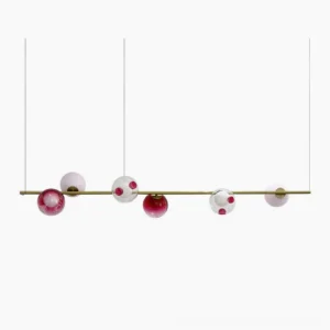 Sedna linear chandelier six-light pendant with brass rod and mixed glass orbs in gold, pink, red, white, and clear - studio front view