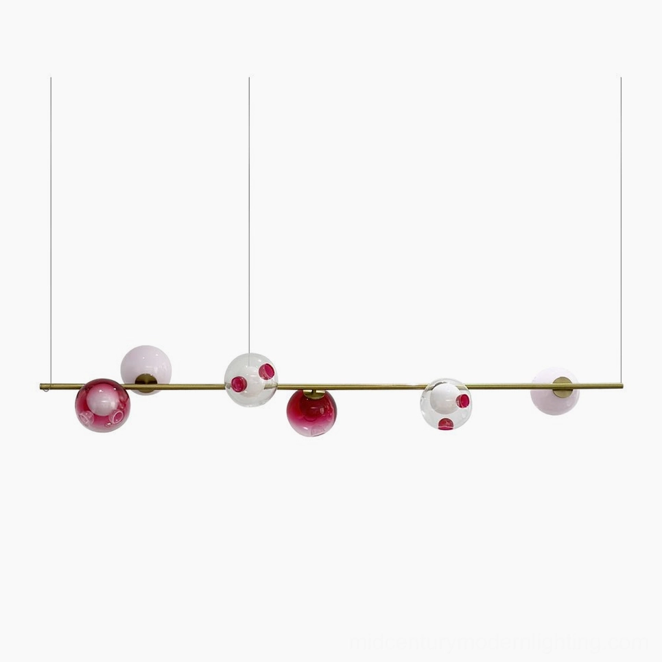 Sedna linear chandelier six-light pendant with brass rod and mixed glass orbs in gold, pink, red, white, and clear - studio front view