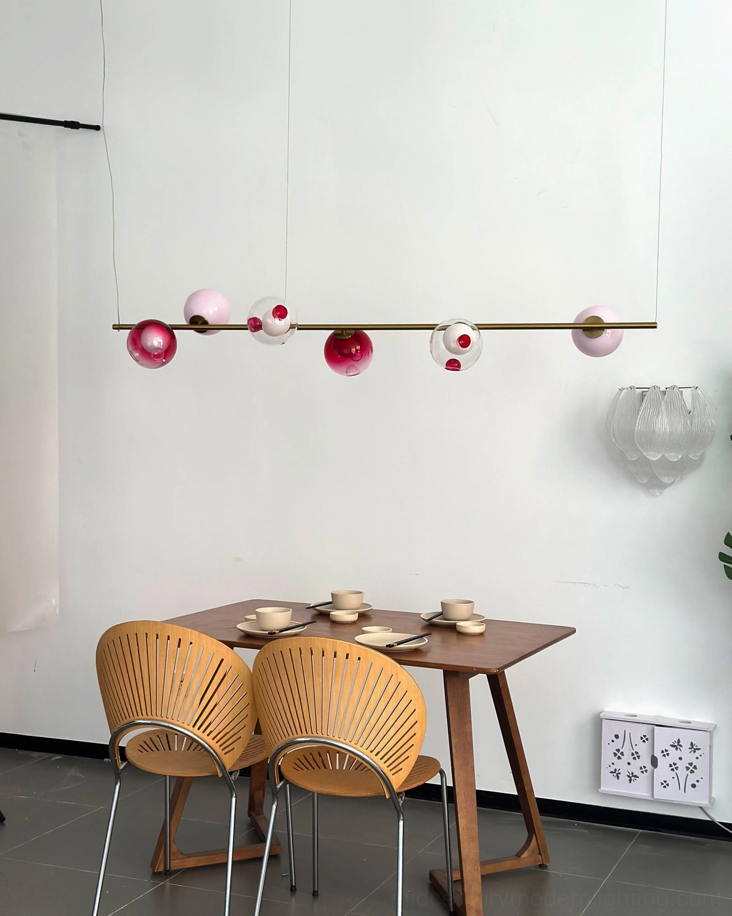 Sedna six-light linear pendant light fixture displaying full suspension mechanism and wire configuration