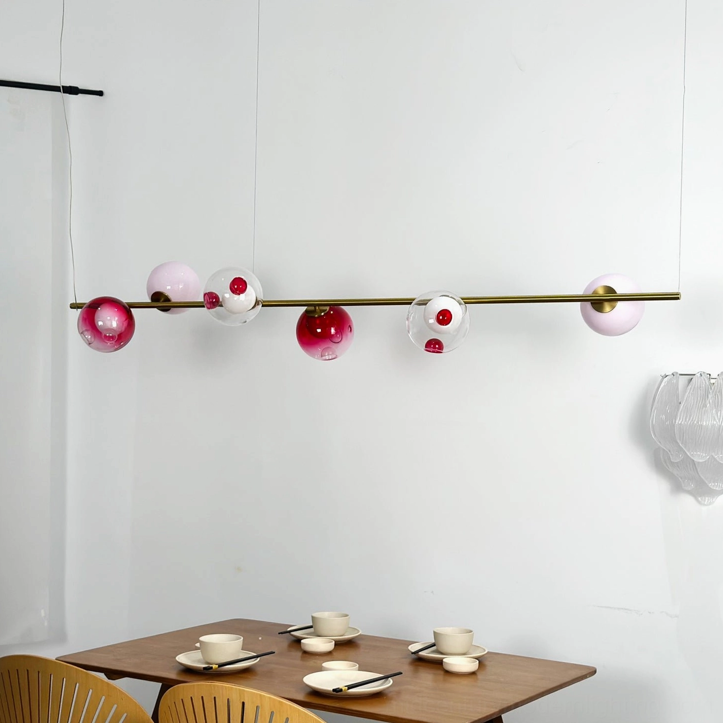 Sedna linear pendant light fixture hanging from ceiling showing complete six-bulb configuration and design composition