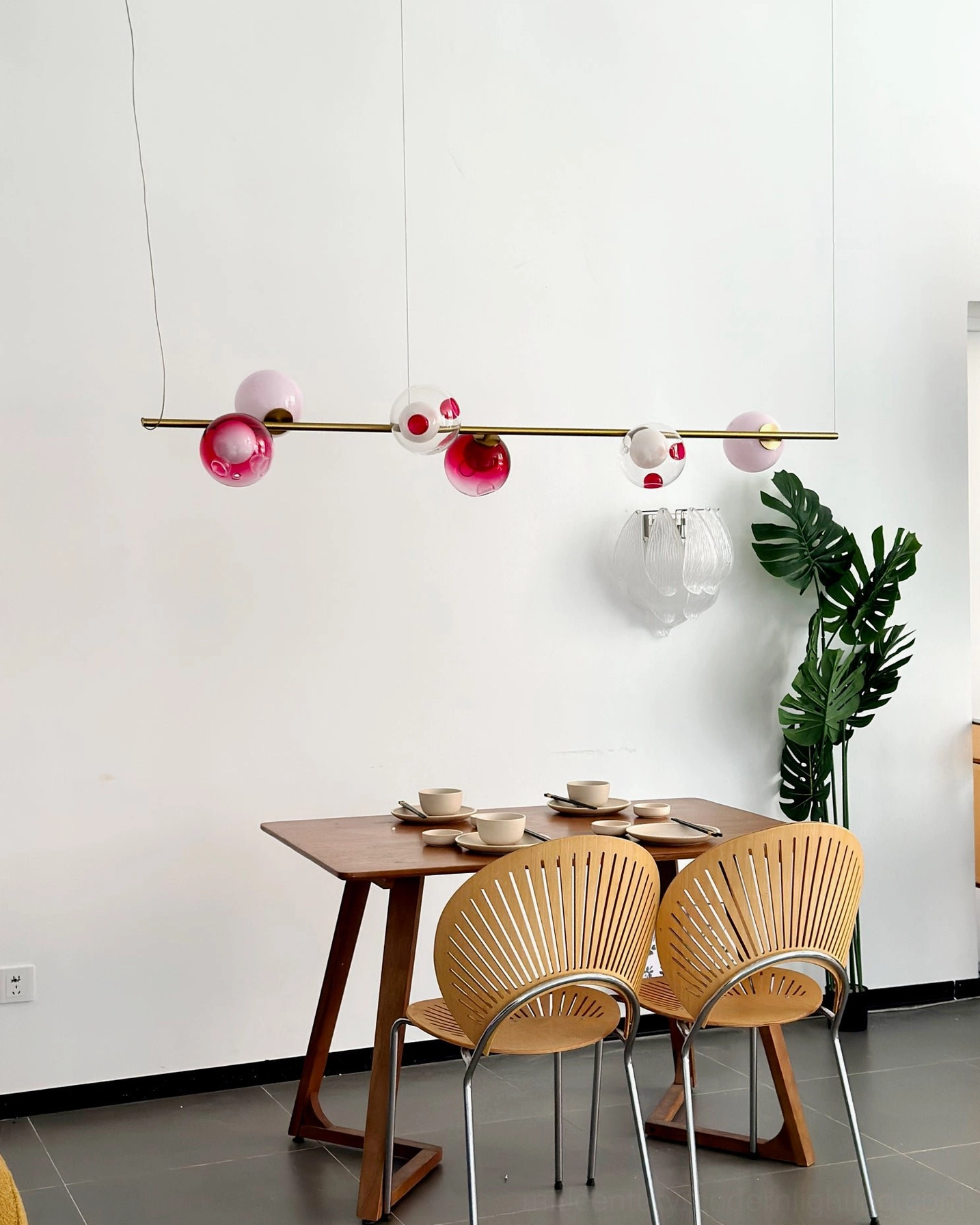 Sedna linear chandelier interior design mockup showing brass and colored glass orb arrangement in mid-century modern setting