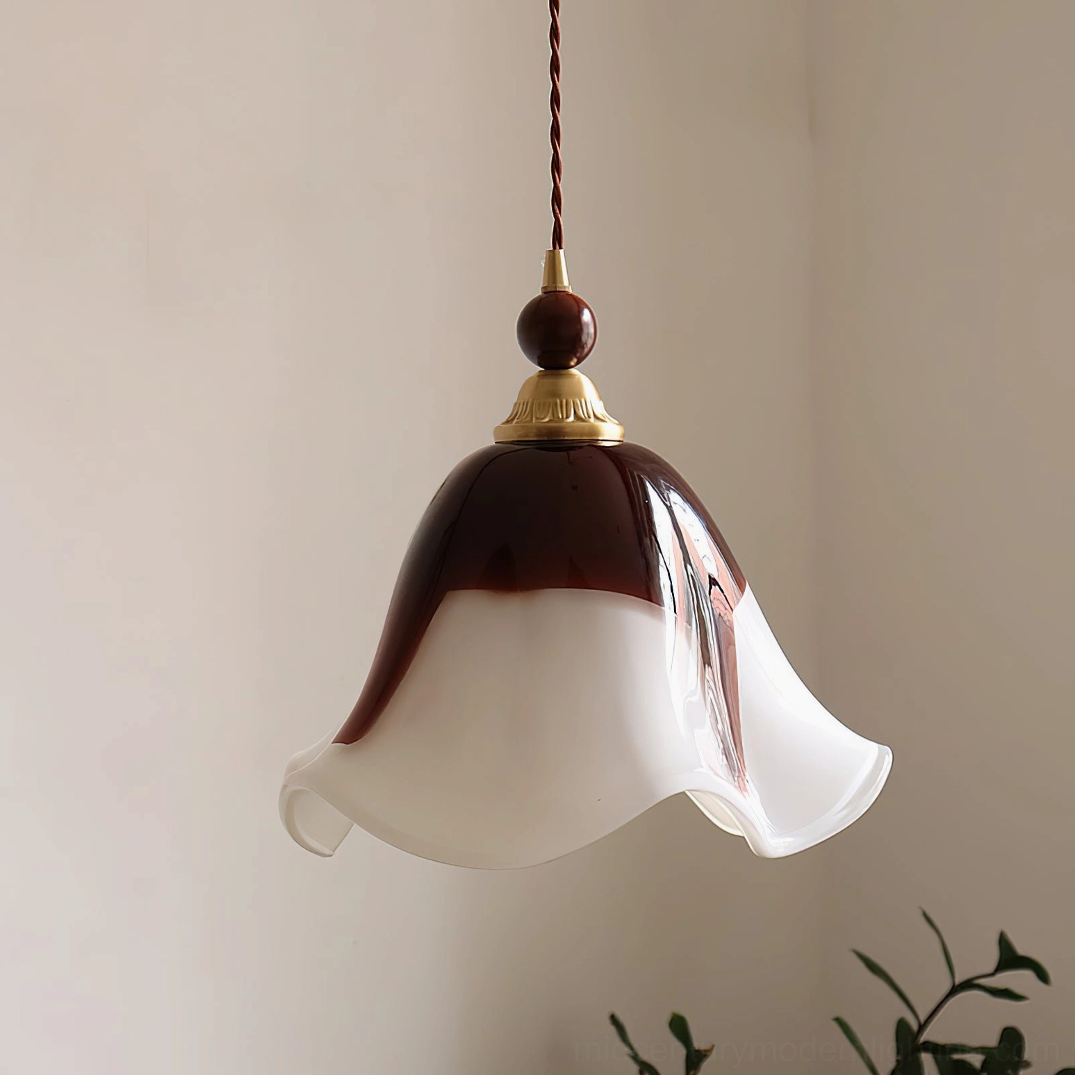 Side profile view of Selene pendant light showing petal-shaped glass shade and brass hardware details