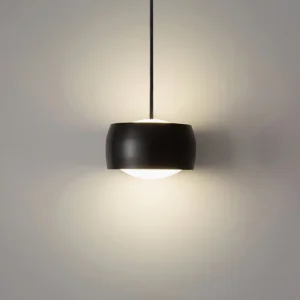 Matte black Sento Sospeso three-color changing pendant lamp, close-up frontal view showing cylindrical design