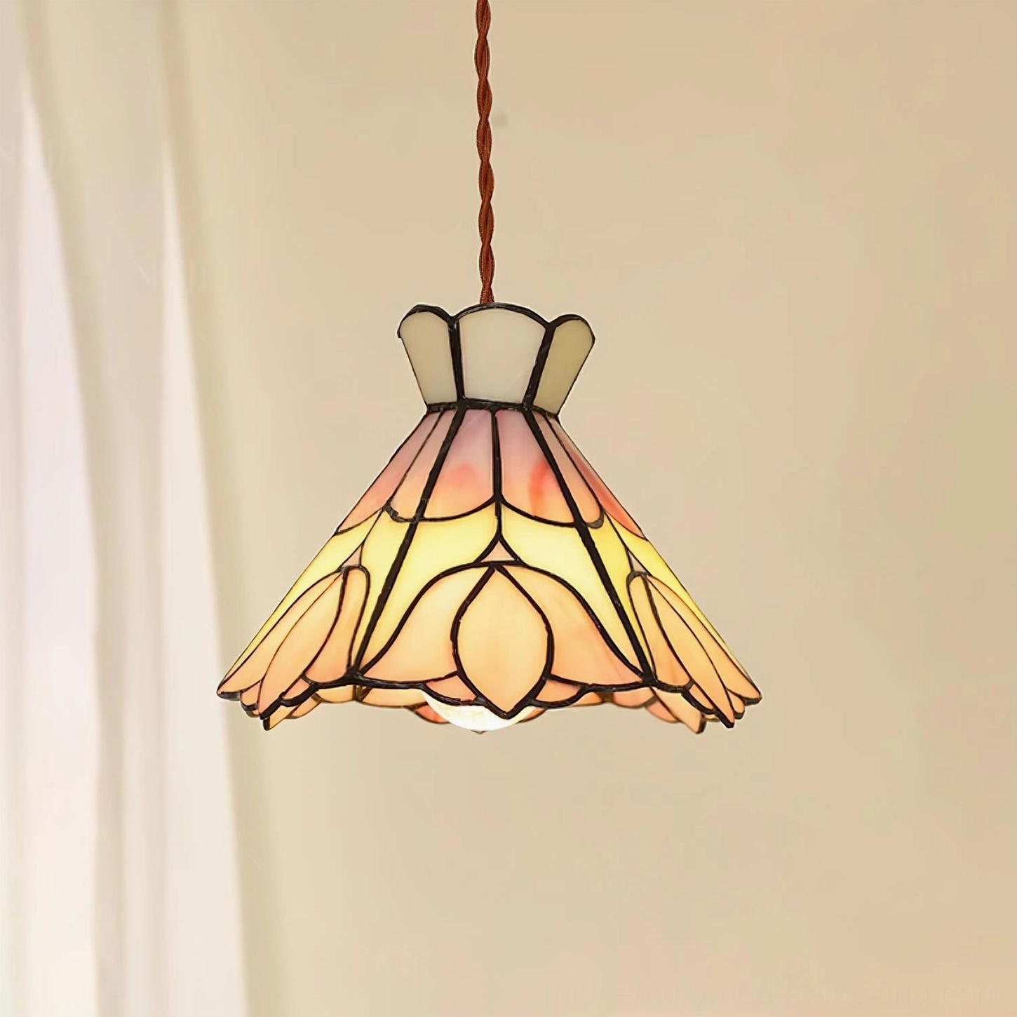 Serena tulip stained glass pendant light hanging indoors with cream trim and black metal framing details