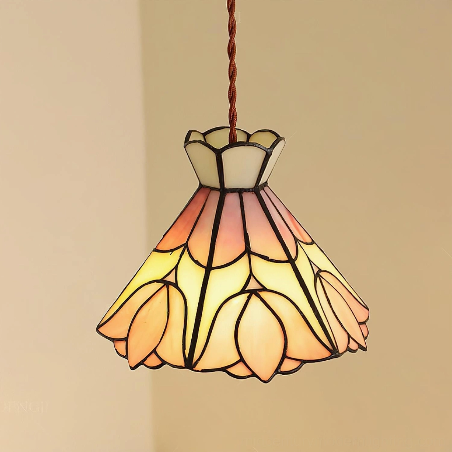Serena lit tulip pendant lamp illuminated in warm indoor setting showing orange-pink gradient glass finish