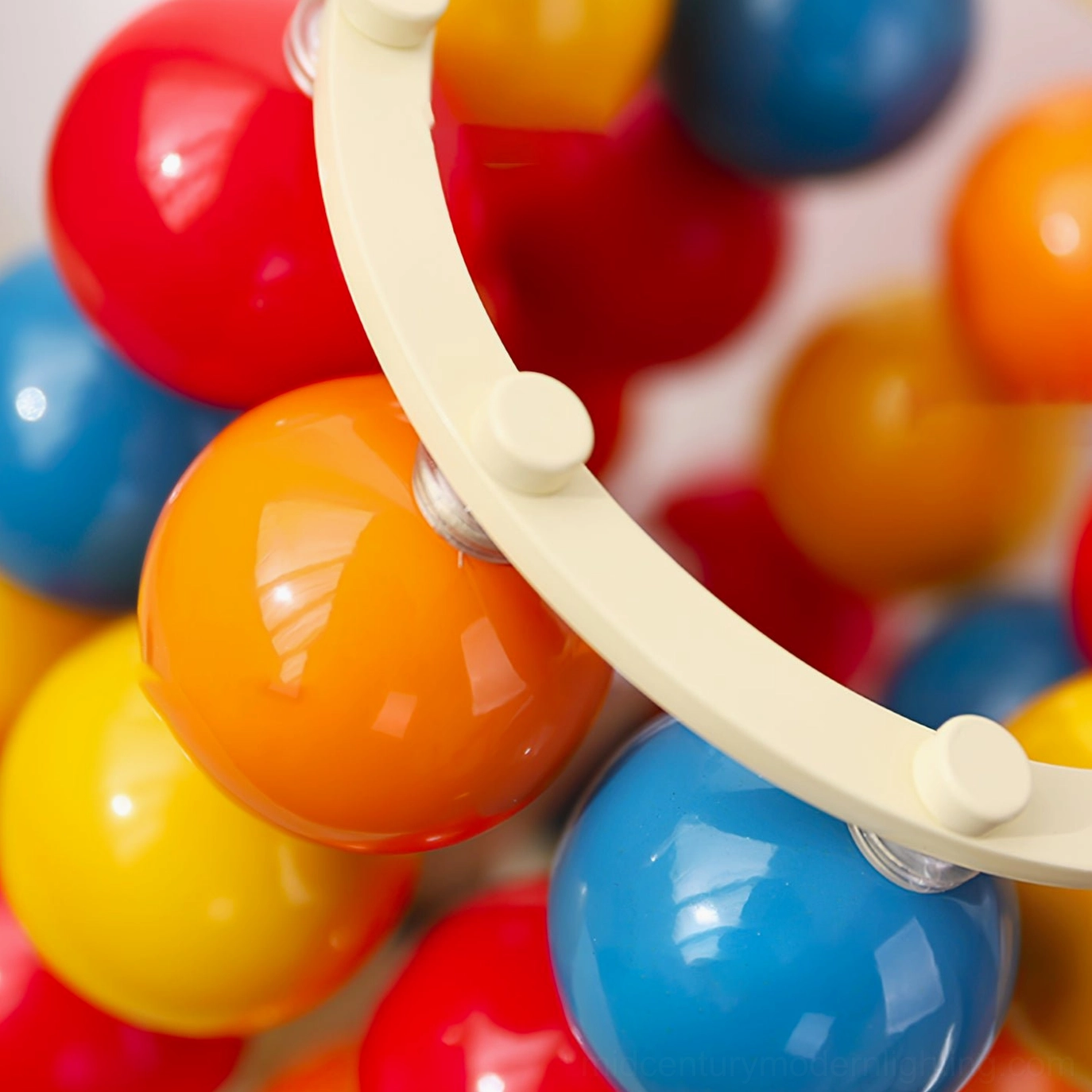 Close-up detail of Sfera spherical lamp showing glossy multi-hued metallic surface