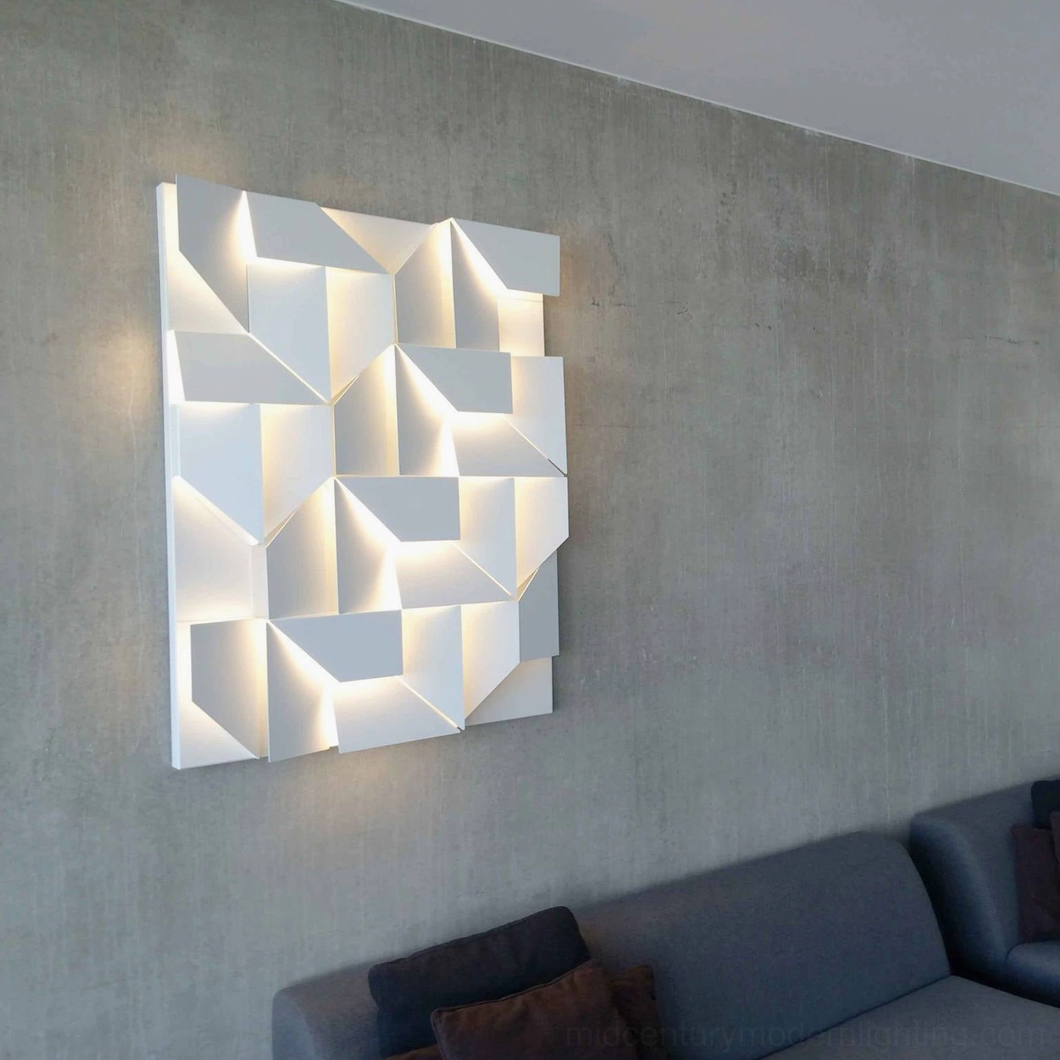 Abstract geometric wall sconce with white aluminum frame and backlit LED illumination