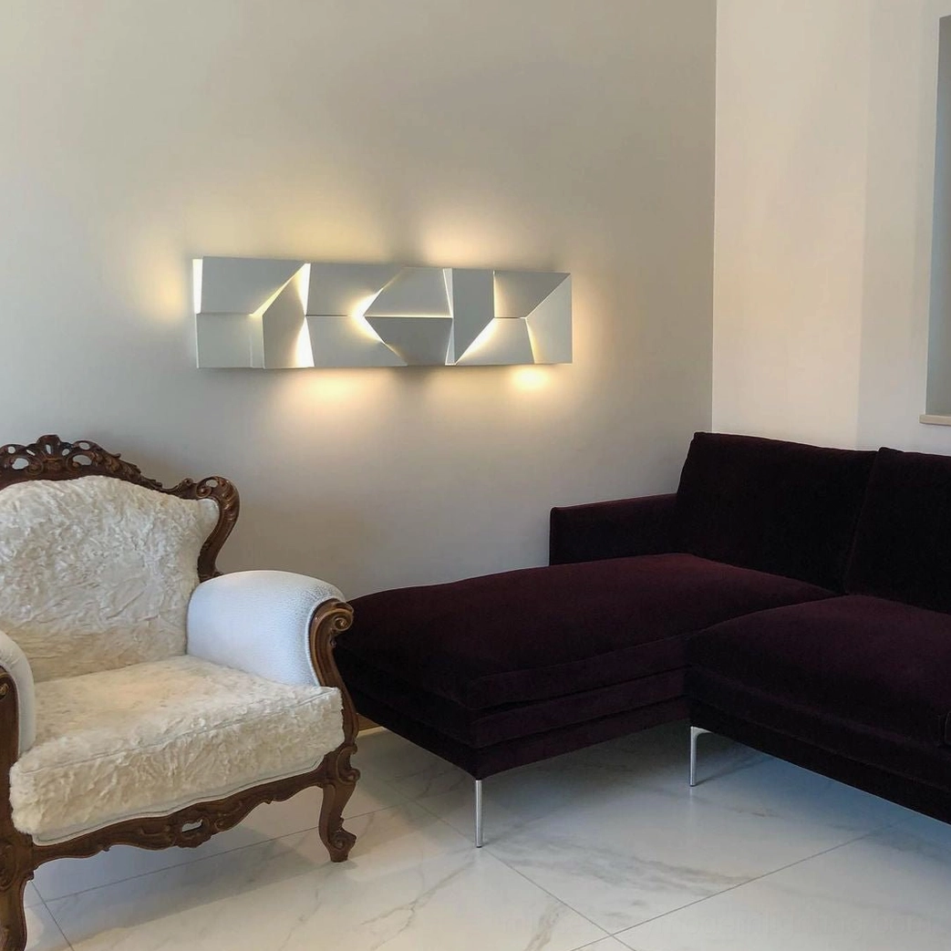 Shadows abstract geometric wall sconce with warm LED illumination, minimalist style
