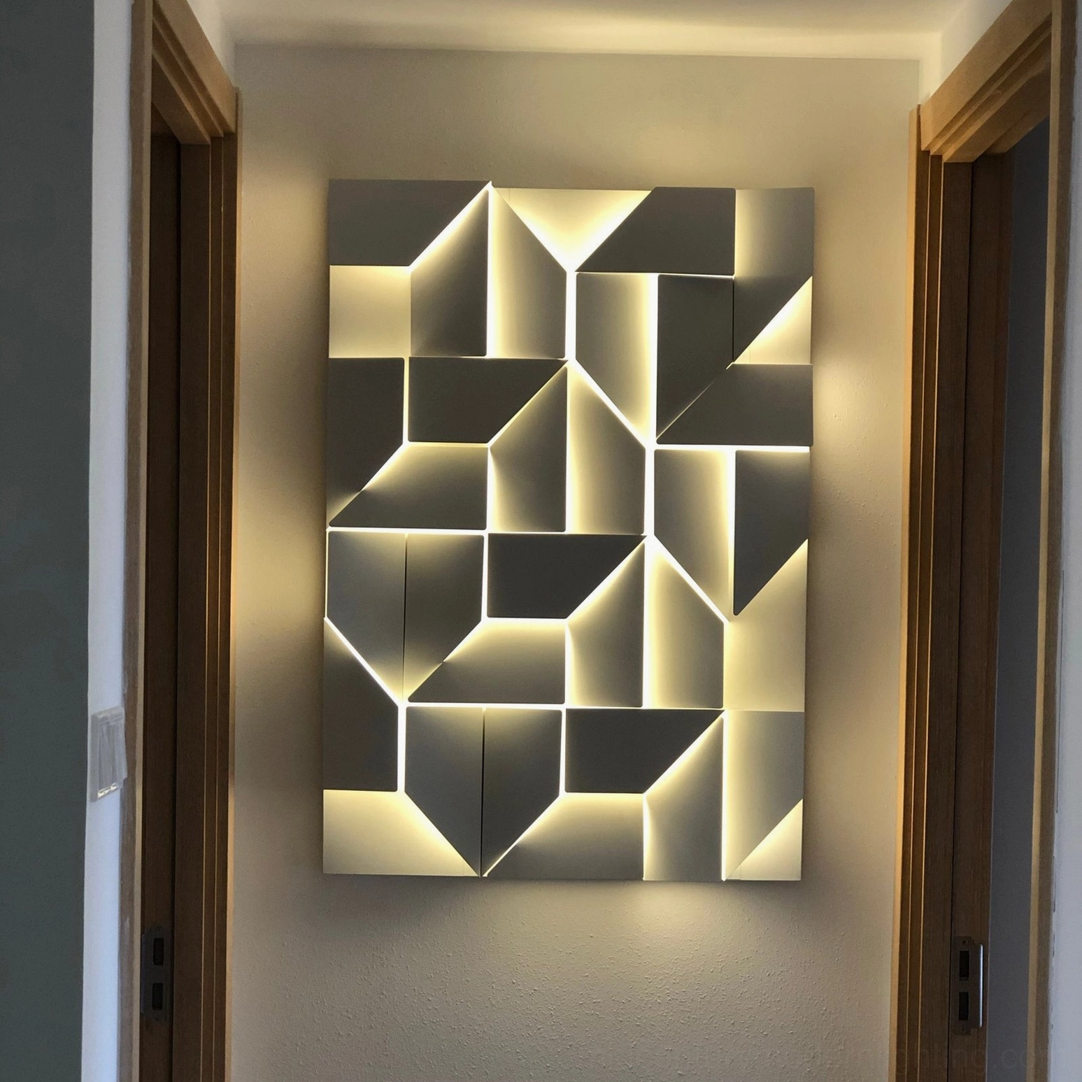 Contemporary architectural wall lamp with geometric cutout design, integrated LED light